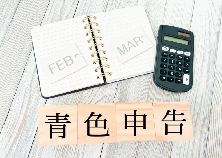 青色申告の文字とノートと電卓の画像