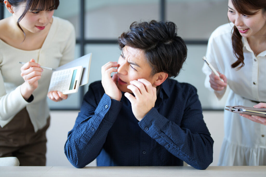 女性たちに注意されている男性会社員